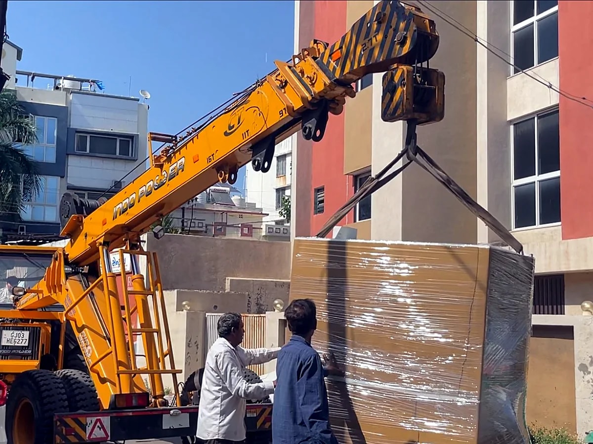 Dispatch — packed machine lifted by crane